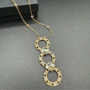 Belladonna Circular Crystal and Gold Tone Infinity Pendant Necklace